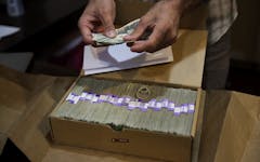 Los Angeles legal cannabis consumers will pay an estimated $128 million to the city in 2021. Above, a 2017 AP file photo of a dispensaries' monthly tax payment. (AP Photo/Jae C. Hong,File)