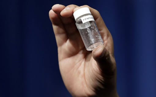 FILE - In this June 6, 2017, file photo, a reporter holds up an example of the amount of fentanyl that can be deadly after a news conference about deaths from fentanyl exposure, at DEA Headquarters in Arlington, Va. The chief justice of the Massachusetts Trial Court told prosecutors she fears that allowing fentanyl and carfentanil into courtrooms as evidence puts people at risk even when the drugs are properly packaged. Some medical experts said a proposal to ban them from courtrooms appears to be driven by a misguided understanding of the real dangers of the substances.