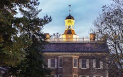 majestic capitol building at night, with a lit-up tower