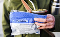 A woman holds her bag of legal marijuana and "mate" herbal drink, outside the pharmacy where she bought the marijuana in Montevideo, Uruguay, Wednesday, July 19, 2017. Marijuana is going on sale at 16 pharmacies in Uruguay, the final step in applying a 2013 law that made the South American nation the first to legalize a pot market covering the entire chain from plants to purchase. (AP Photo/Matilde Campodonico)