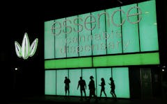 In this April 16, 2018, file photo, people stand outside after shopping at the Essence cannabis dispensary in Las Vegas. Nevada's marijuana regulators say they are trying to keep up with demands at recreational dispensaries, where sales continue to outpace projections. The Nevada Appeal reports the Interim Finance Committee approved an additional $1.5 million for the Department of Taxation to hire more security guards and staff to process background checks for workers at marijuana facilities. (John Locher/AP)