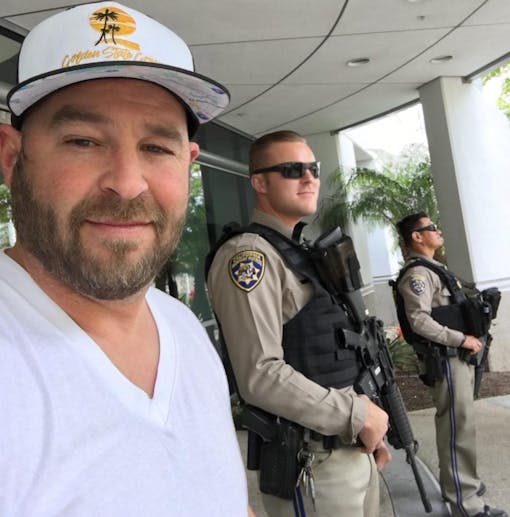 A San Diego cannabis operator pays his taxes at city hall as armed officers stand by. (Courtesy of Golden State Green)