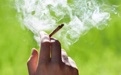 Joint in hand smoke lit