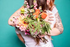party etiquette, people hugging with bouquet of cannabis flowers