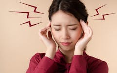 cannabis topicals headache migraine; woman rubbing temples