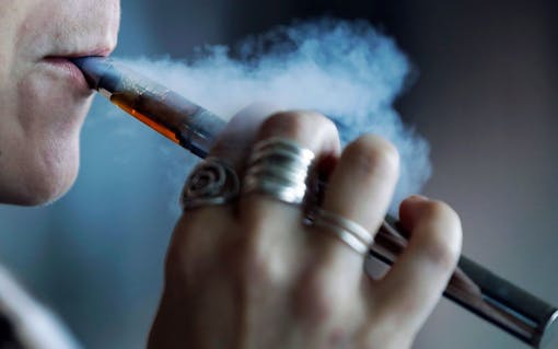 On Nov. 8, the Centers for Disease Control and Prevention confirmed Aug. 30 Leafly findings of a new, toxic cutting agent in the illicit THC vape cart supply chain—vitamin E acetate. Above, a woman using a vaping device in Mayfield Heights, Ohio (Tony Dejak/AP)