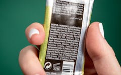 Leafly cannabis topicals ingredients; hand holding hemp cream with list of ingredients