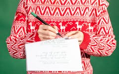 Cannabis holiday etiquette; person in Christmas sweater writing gift list