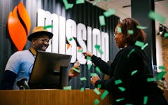 Edie Moore (right), executive director of Chicago NORML makes the first purchase on the first day of recreational cannabis sales in Illinois at Mission dispensary in Chicago, Illinois, Jan. 1, 2020. (Taylor Glascock/Leafly File Photo)