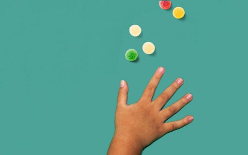 child's hand reaching for candy ;what happens when kids eat marijuana edibles