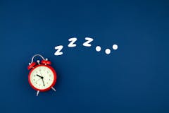 Alarm clock on blue background