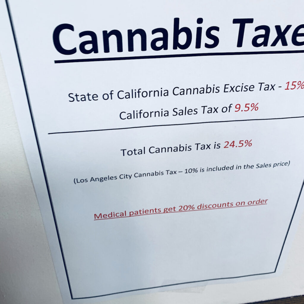 A picture of a sign in a licensed Los Angeles cannabis store tried to explain the triple-taxation, one layer of which is hidden from receipts. (David Downs/Leafly)