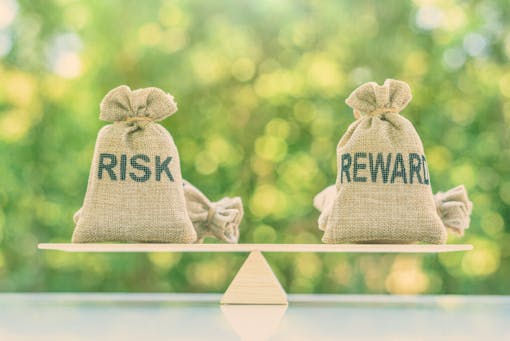 Risk and reward being balanced on a simple scale