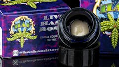 A picture of a light rosin ball in a dark jar on a black baground. Pre-legalization brand Hash and Flowers returns to legal dispensary shelves with gorgeous, terpy, single-source, vertically integrated Strawberry Guava live rosin. (Courtesy Hash and Flowers)