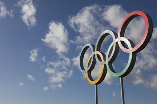Photo of the Olympic rings against a blue sky background