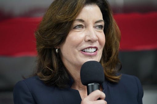 photograph of New York Governor Kathy Hochul holding a microphone
