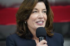 photograph of New York Governor Kathy Hochul holding a microphone