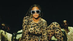 Still of Beyonce from her film, Black is King in a cheetah print outfit and sunglasses
