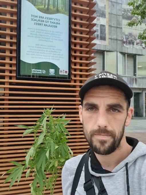 photo-of-martin-condon-standing-beside-a-cannabis-plant