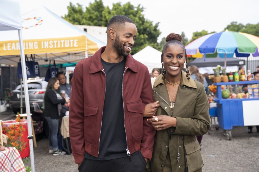 Insecure's Issa and Lawrence stroll through an outdoor market