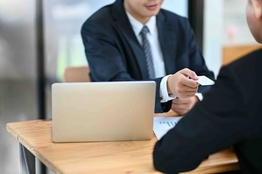 photo-of-two-people-exchanging-business-cards