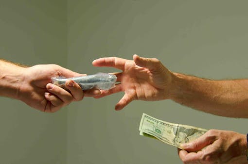 photo-of-people-exchanging-money-for-cannabis