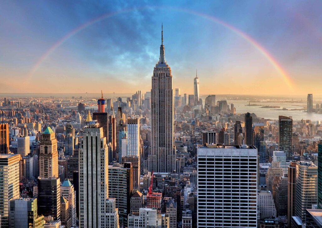 New York City skyline with urban skyscrapers and rainbow.