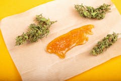 dried cannabis bud with concentrate wax oil closeup.