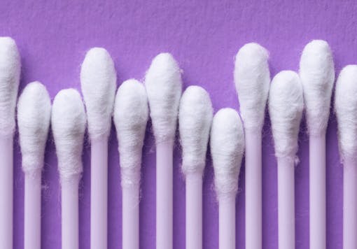 cotton swabs on a purple background