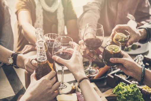Group of people having meal togetherness dining toasting glasses