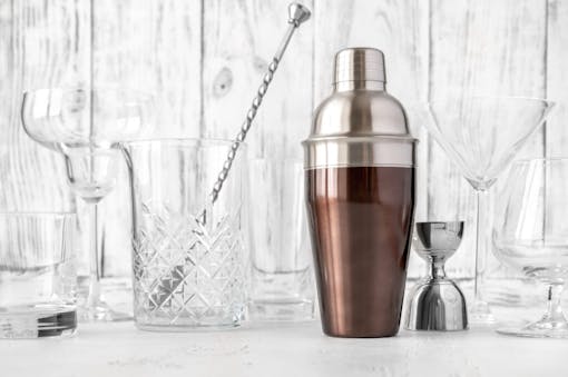 Assortment of barware and glassware on wooden background