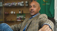 Photo of Virgil Grant seated in dispensary