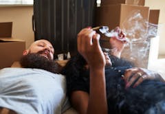 interracial couple relaxing after hard work moving while laying on floor