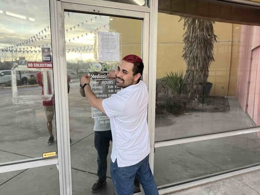 photo-of-a-budtender-at-a-dispensary-door