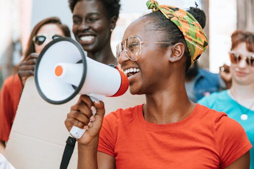 Woman smiling and holding a megaphone