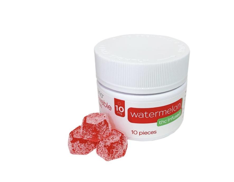 small red gummy bears next to a white plastic container with gummy bears