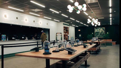 A medical patient checks out in peace at RISE dispensary in Bloomfield while hundreds of rec buyers fill day-one lines on the other side of the store. (Meg Schmidt, Leafly)