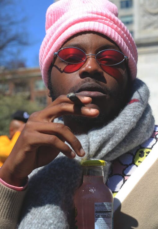 A man smokes a blunt in New York's Washington Square Park.