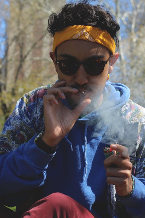 A man hits a joint in New York's Washington Square Park.