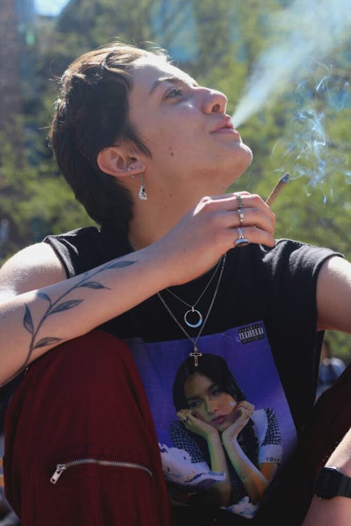 A woman smokes a joint in New York's Washington Square Park.
