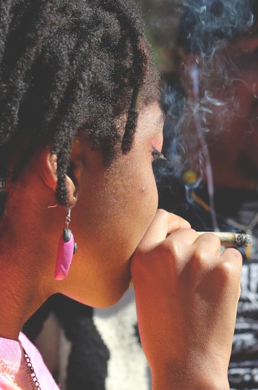 A woman smokes a joint in New York's Washington Square Park.