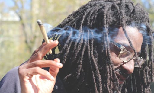 Man smokes a joint in New York City's Washington Square Park.
