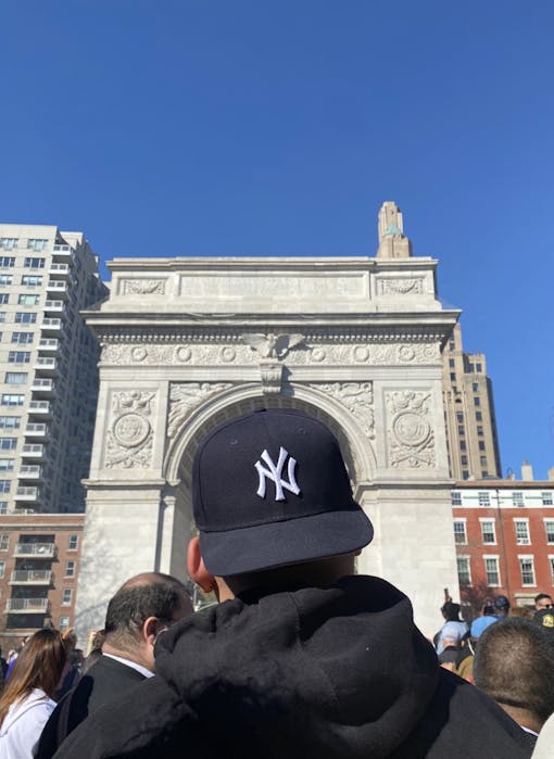 A man in a New York Yankees hat stands in Washington Square Park during a 420 smoke sesh hosted by The Astor Club.