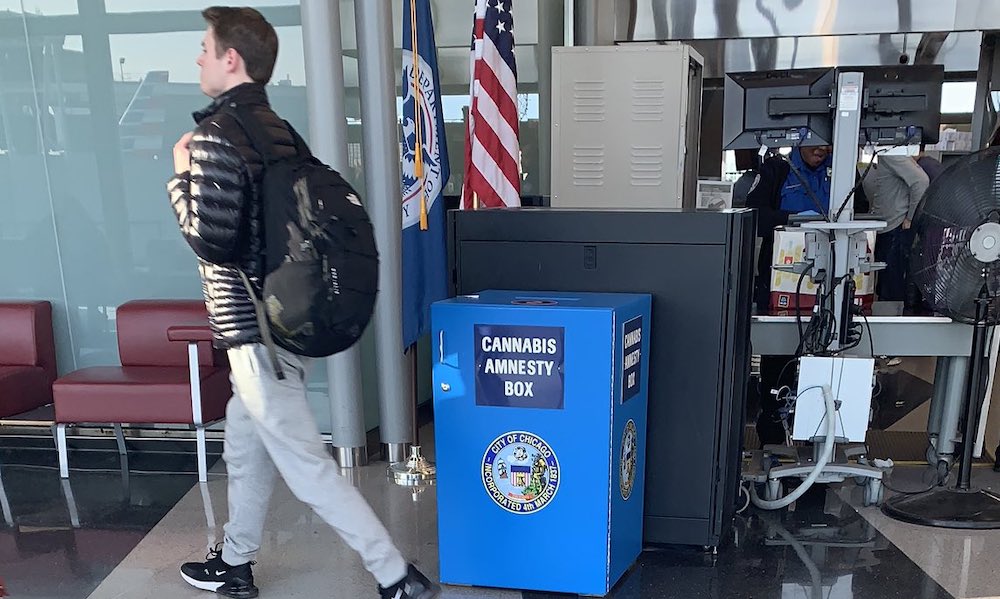 A man walks past a blue amnesty box next to the TSA screening area