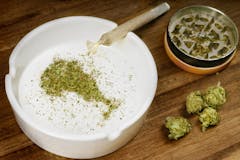 Crumbled weed in the shape of Ontario and a joint. (series)