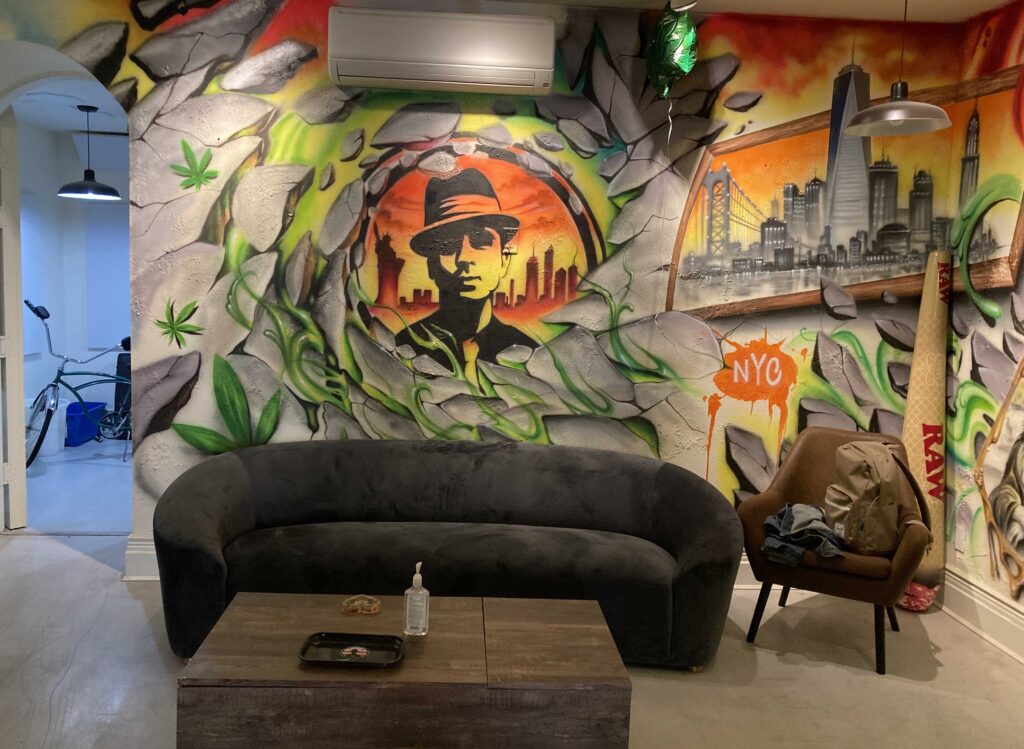 Couch and NYC mural in lounge with huge Raw cone in corner
