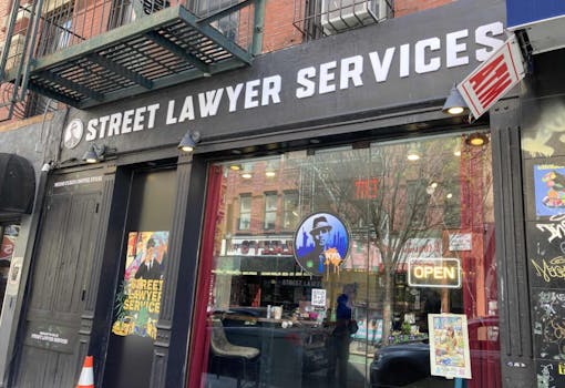 exterior building shot of street lawyer services, black trim and big glass floor to ceiling windows facing street