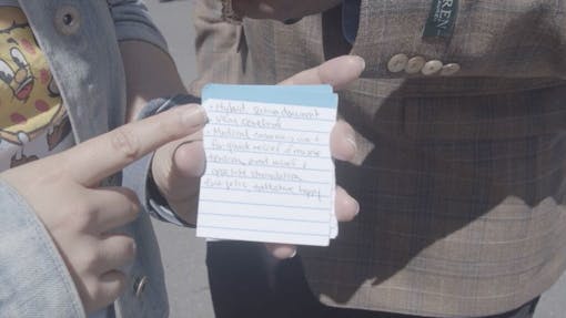 New York woman shows index cards with strain data she found on Leafly. (Jon Bain / Leafly)