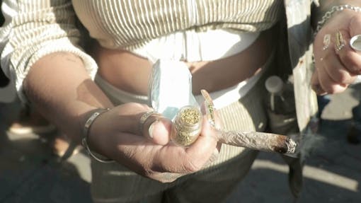 New York woman shows off her 420 stash in Washington Square Park. (Jon Bain / Leafly)