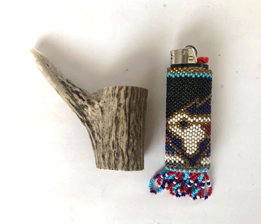 photo of antler pipe and lighter